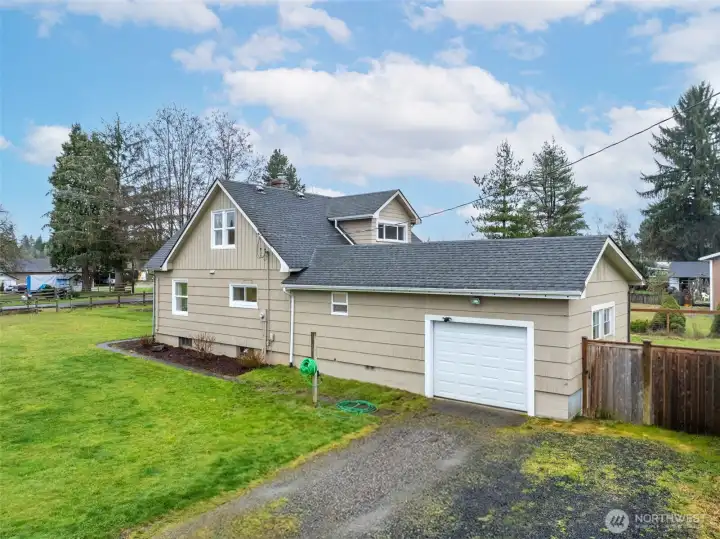 This is the west side of the home. Here you can see the attached, oversided one-car garage. A few more weeks and the hydrangeas will be in bloom!