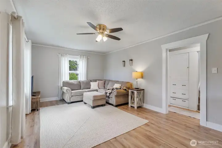 Here's an opposite look at the living room. The doorway to the right leads to a bedroom, built-in linen storage, and then upstairs.