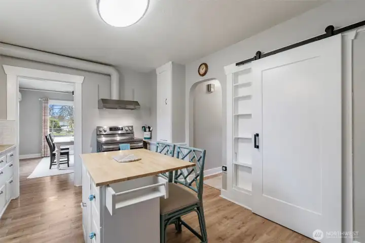 Opposite wall of the kitchen. Here you can see the pantry door plus through to the dining room and hallway