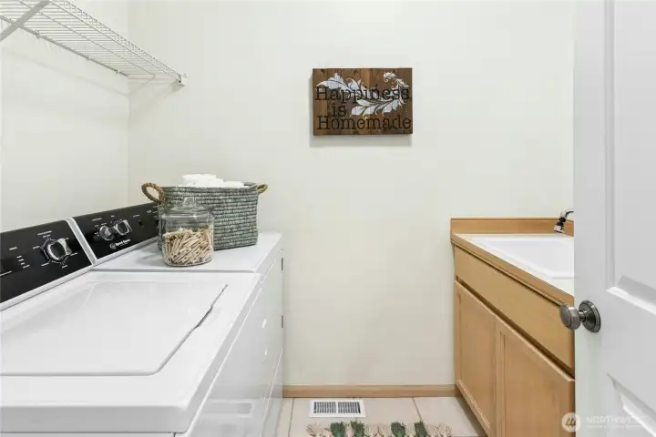 This large laundry/utility room is on the main with sink and counter (and storage!)