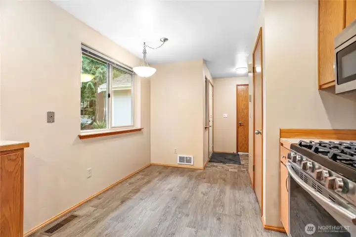 Breakfast nook area looking toward entryway and door to garage