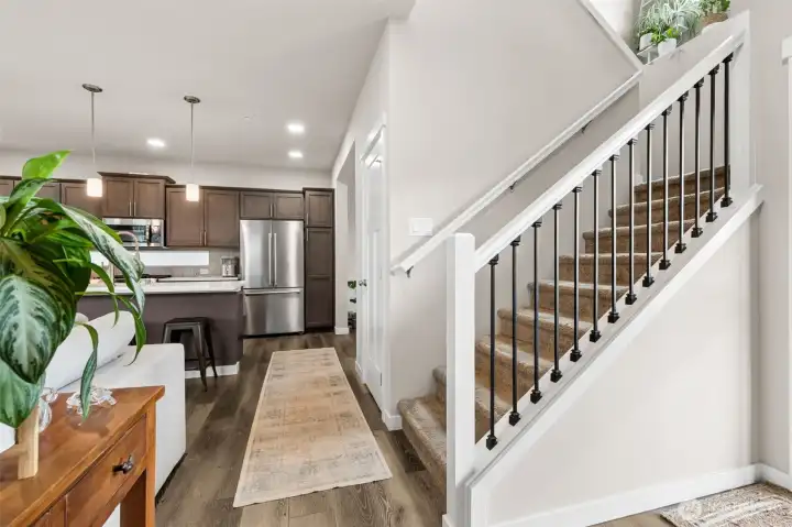 Open rail on the stairwell creates an elevated entrance.