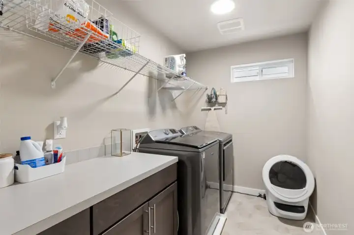 Upstairs hall laundry with storage.