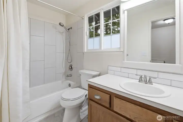 Upstairs guest bathroom with new tile surround shower.