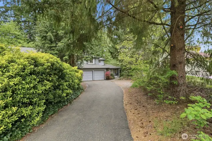 Relaxing long driveway for an inviting approach to the home doubles as additional parking for guests.