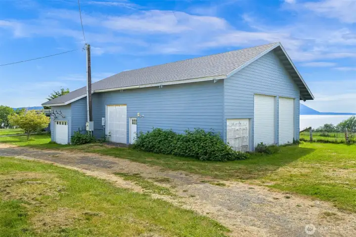 Large detached shop next to house has generous interior space, ideal for workshop use, equipment storage, or hobby projects. Large detached shop next to house has generous interior space, ideal for workshop use, equipment storage, or hobby projects.