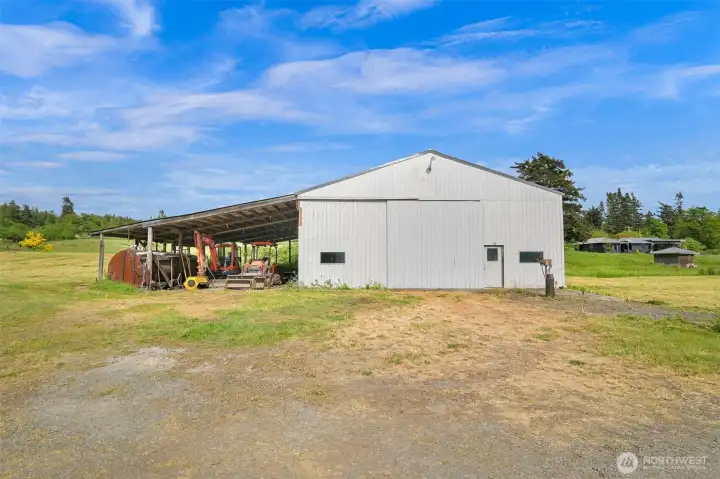 Expansive shop/pole building with soaring ceilings, oversized doors, and flexible room for equipment, storage, projects, or future workspace needs. Expansive shop/pole building with soaring ceilings, oversized doors, and flexible room for equipment, storage, projects, or future workspace needs.