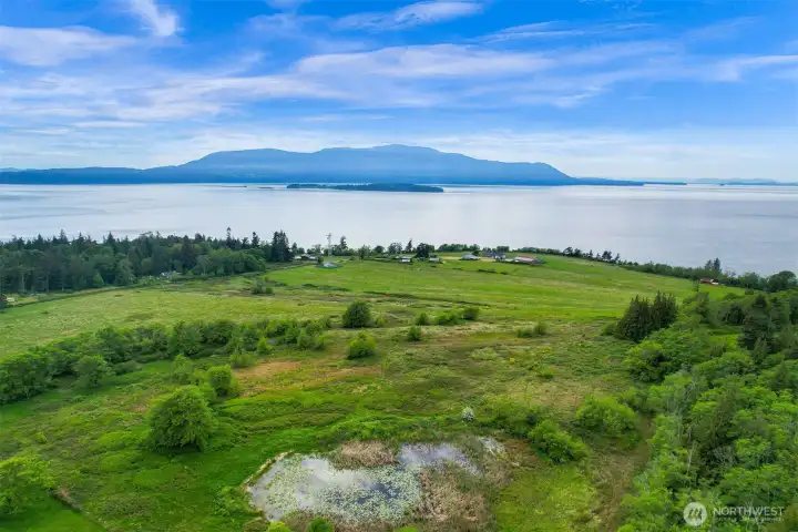 Elevated aerial view highlighting the property’s scale, shoreline access, and surrounding natural beauty. Elevated aerial view highlighting the property’s scale, shoreline access, and surrounding natural beauty.