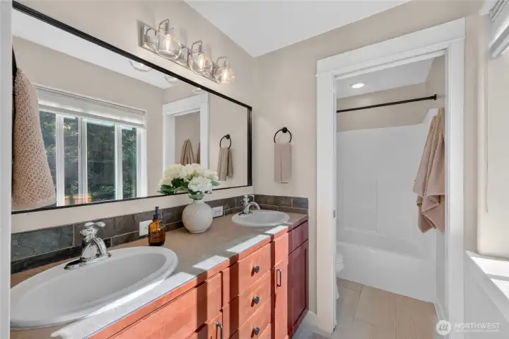 The primary bathroom is light and bright too.