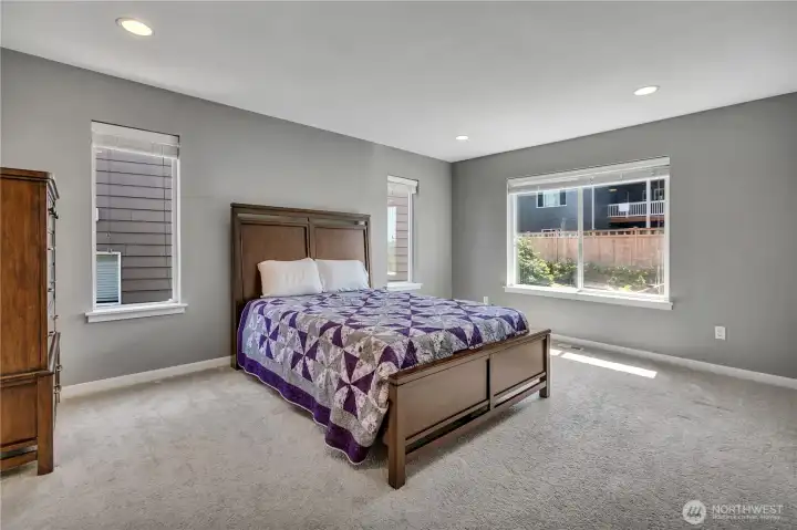 Enormous primary suite with large picture window, dual side windows, and generous wall space for additional bedroom cabinets and desks! Enormous primary suite with large picture window, dual side windows, and generous wall space for additional bedroom cabinets and desks!