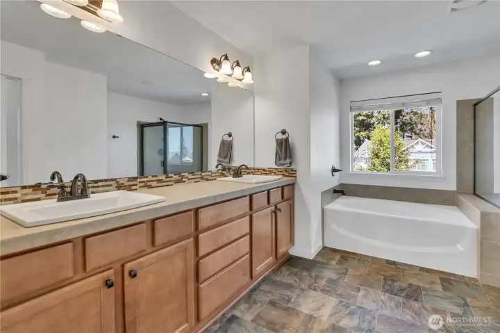 Generous 5-piece primary bath features double vanities, soaking tub, separate glass & tile shower, and separate private, commode. Generous 5-piece primary bath features double vanities, soaking tub, separate glass & tile shower, and separate private, commode.
