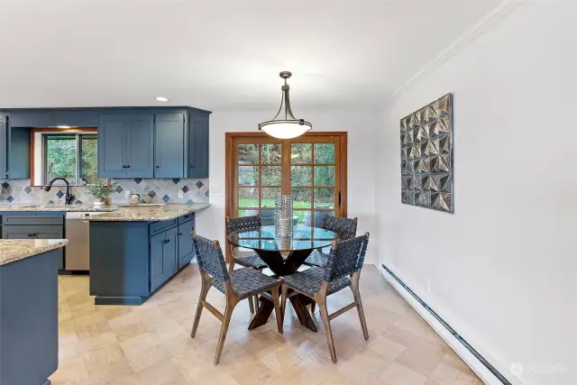 Dining space between living room and kitchen.  French Doors lead to easy deck and patio access!