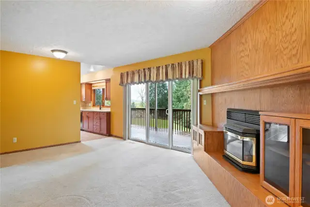 Family room with propane fireplace and sliding door leading to deck