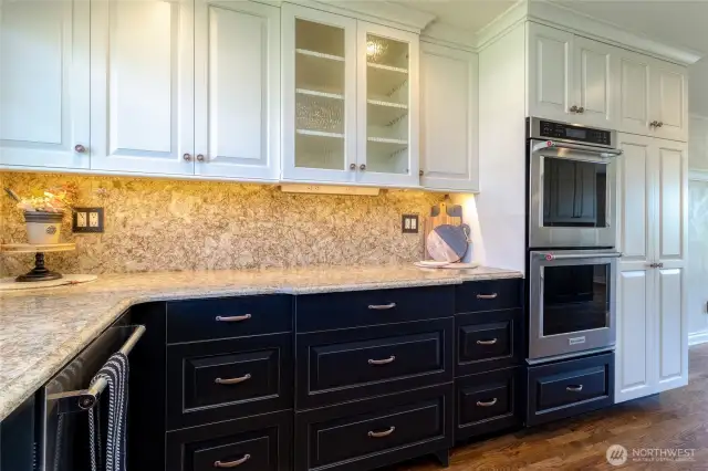 Kitchen features double ovens and an abundance of storage, pantry cupboard with pull out shelves.