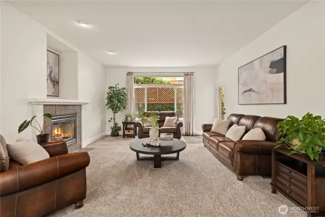 Large living room with gas fireplace, connecting you to the backyard