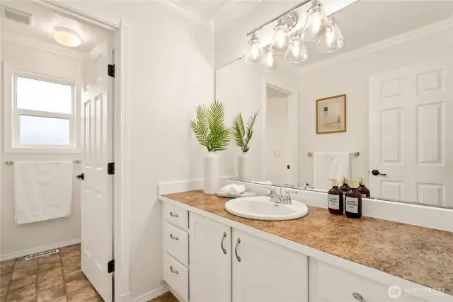 Upstairs bathroom with amazing counter space and a separate door for the shower & commode
