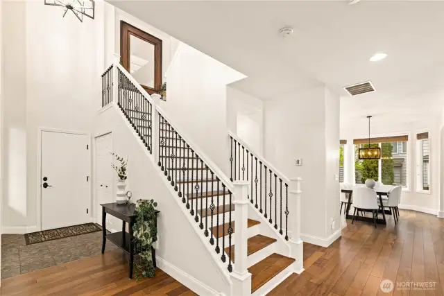 Grand 2-story entrance with an abundance of light! This coat closet is off of the garage, or convert into a shower if you need a main floor suite! Just tap into the powder bath on the other side of the wall. Beautiful hardwood floors throughout the main floor and stairs