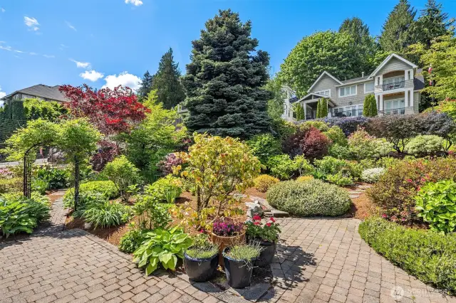 The lush, mature gardens bursting with lilacs, hydrangeas, and hostas create a year-round sanctuary of color and fragrance.