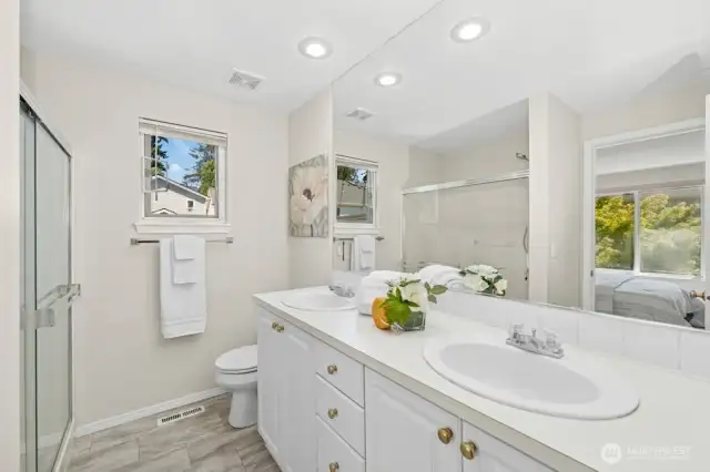 The primary bath has new flooring, dual sinks, and a shower.