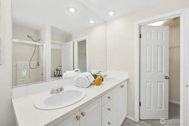 Another look at the primary bath and its connection to the walk-in closet.