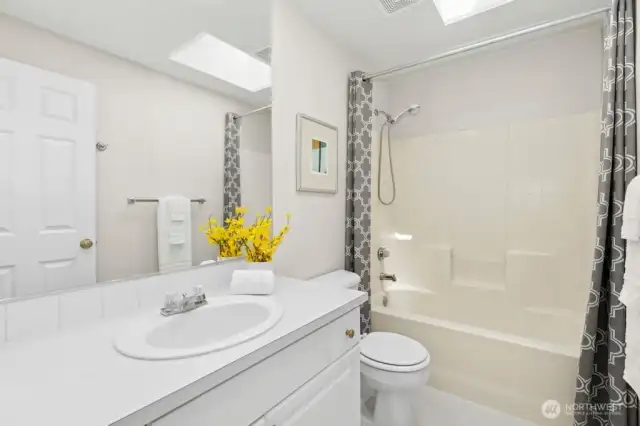 The upper-level full bath. Don't miss the skylight!