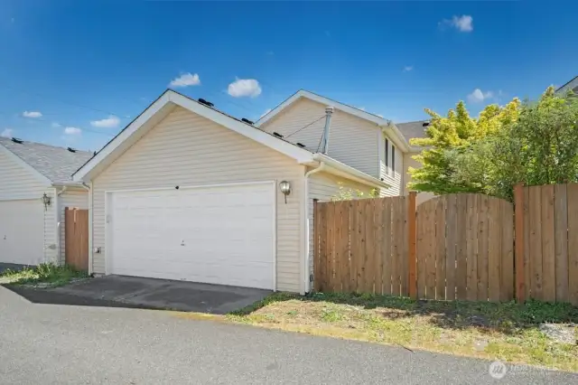 The home is 'alley load' where the garage is accessed by an alley at the back of the home. The gate to the right leads to the backyard.