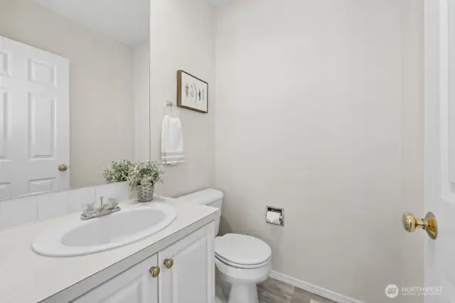 Rounding out the main level is the powder room, adjacent to the garage entrance.