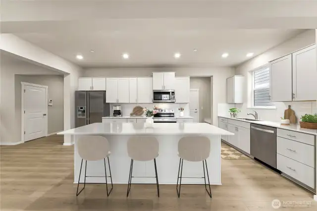 Large center island with eating area. . Actual home is under construction and materials, colors, and finishes will vary. See site agent for details.