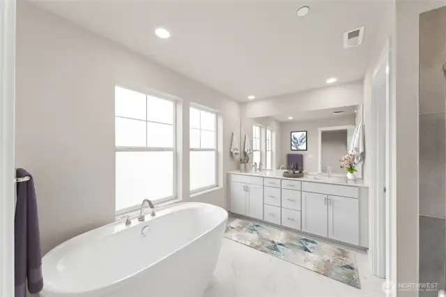 5-pc primary bathroom with separate soaking tub, double sink vanity, and walk-inshower. . Actual home is under construction and materials, colors, and finishes will vary. See site agent for details.