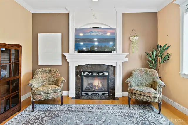 Family room is a true focal point, featuring floor-to-ceiling custom built mantel with a tv niche and a propane fireplace that adds warmth and ambiance.