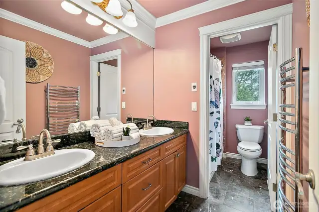 Stylish full bath upstairs featuring dual vanities, granite countertops with a thoughtfully designed layout. Separate shower and toilet for added privacy and functionality.