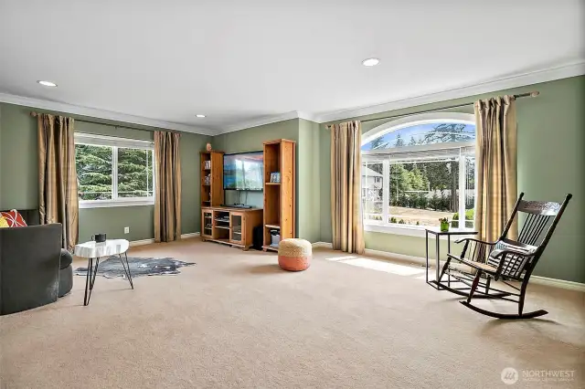 Spacious upstairs bonus room with large arched windows fill this space with natural light. This room is ideal for movie nights, games or as a potential home office or guest suite.  Adjacent to the bonus room is a versatile spare room, perfect for storage, craft room or hobby space.