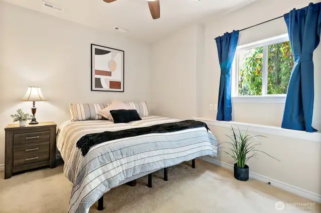 Bedroom downstairs is spacious and has high ceilings.