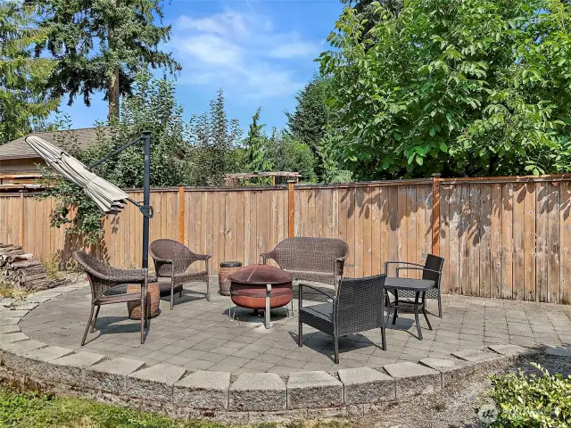 The fully fenced backyard features a designated paved, firepit area.  If you like to garden there is also a greenhouse and a shed for yard tools.