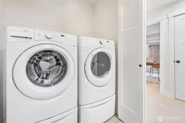 Full-size washer and dryer on upper level.