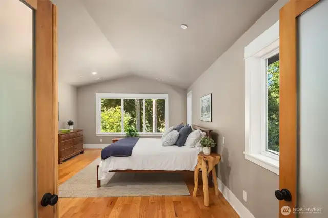Large primary ensuite features nature as a backdrop