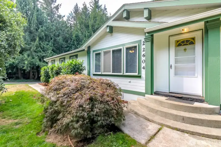 Entry with mature landscaping and Japanese Maple
