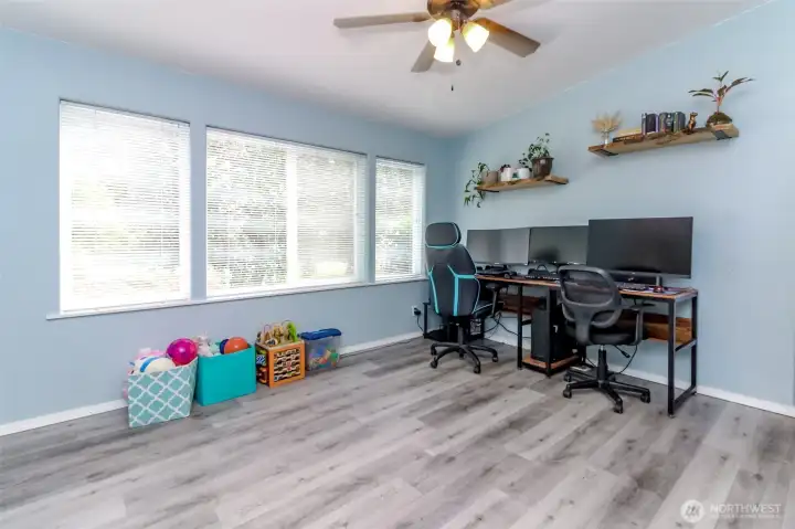 Living room with ceiling fan and tons of light through the large windows