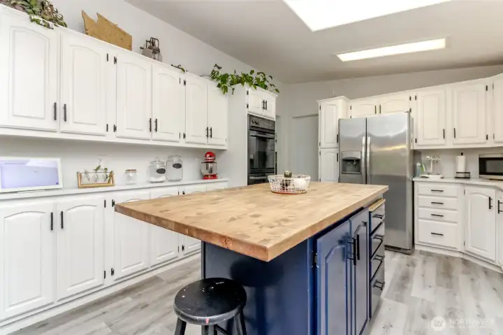Bright kitchen features skylights, large island and tons of storage!