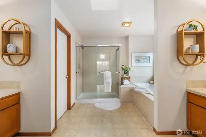 Separate vanities, large hower, soaking tub. Skylight offers more natural light