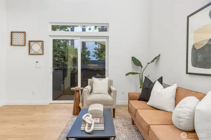 Sliders step out to balcony overlooking the lovely tree lined street.