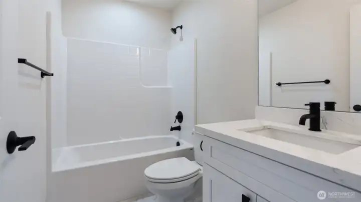 Main Bathroom has quartz counter, undermount sink and beautiful tile flooring.