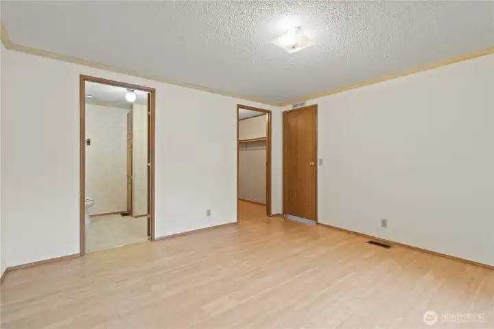 The primary bedroom with en-suite bath and walk in closet.