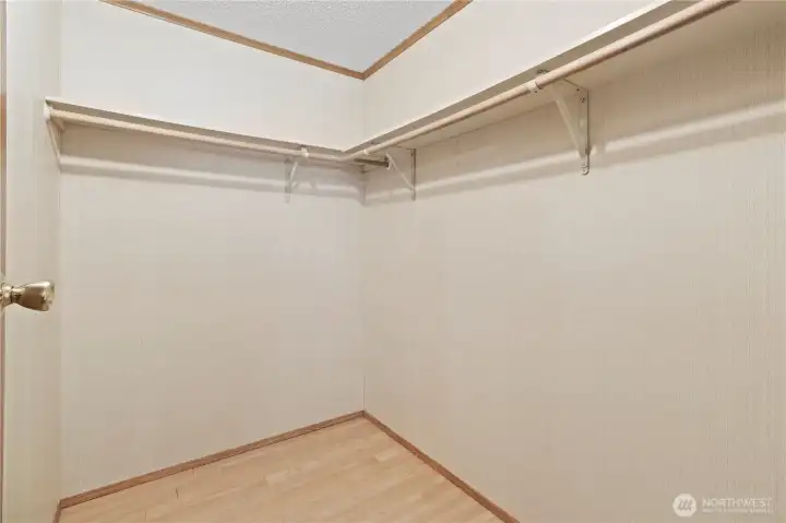 Walk in closet in primary bedroom.