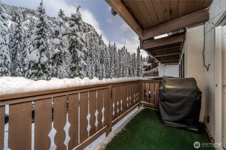 Private balcony overlooking the river with scenic mountain views beyond—an ideal spot to enjoy fresh alpine air, snowfall, and peaceful surroundings year-round.