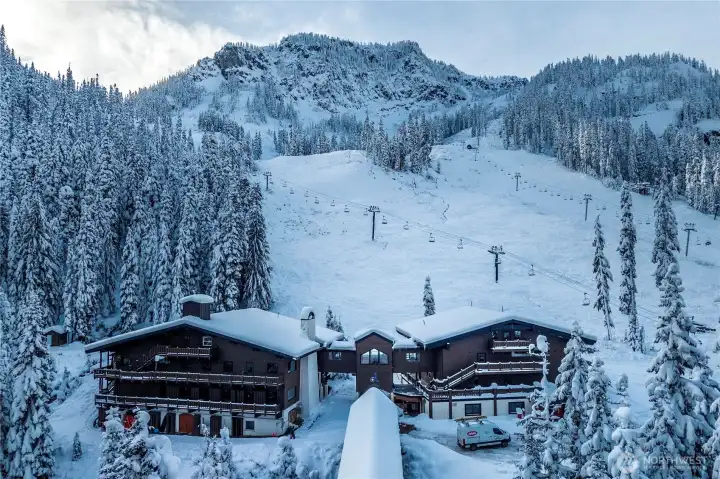 Iconic Alpental Lodge nestled at the base of the slopes, offering immediate access to chairlifts, trails, dining, and après-ski in a classic alpine setting.