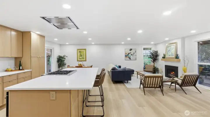 The open-concept great room offers comfortable everyday living and easy entertaining, with expansive windows that fill the space with natural light and highlight clean lines and warm, modern finishes.