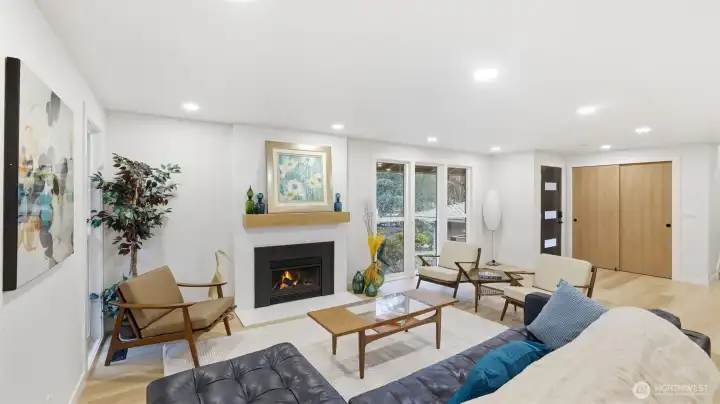 Flooding the space with natural light, oversized windows and a cozy fire create the perfect spot to unwind.