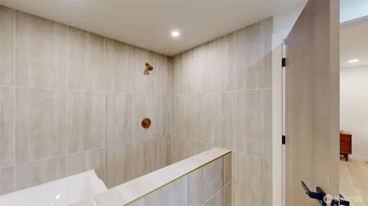 The showstopper in this primary is the walk-in shower – spacious, stunning tile, and a large soaker tub inside, too.