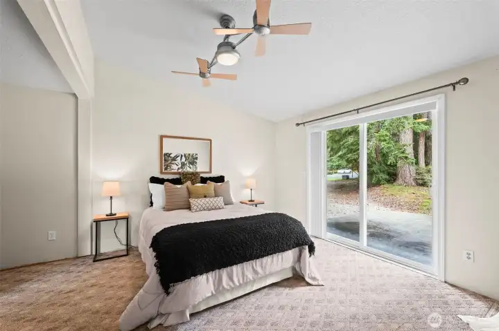 Primary bedroom with slider to back patio.